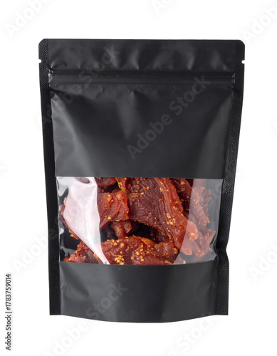 Beef jerky in a black stand up pouch, displaying savory dried meat snack with chili flakes through clear window