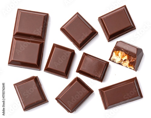 Dark chocolate squares arranged against a stark white backdrop. One piece shows a filled center