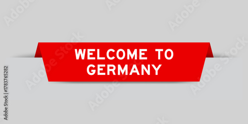 Red color inserted label with word welcome to germany on gray background