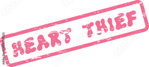 Distressed pink rubber stamp featuring the intriguing phrase Heart Thief on a white canvas