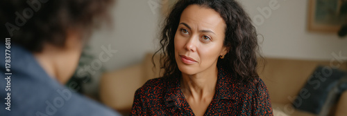 A woman listens intently during a meaningful dialogue, capturing the essence of active listening and emotional connection in personal interactions, showcasing deep understanding.