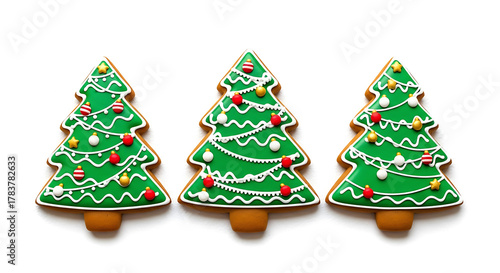 Three decorated green Christmas tree shaped cookies with white icing image