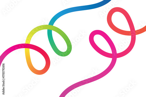 Vibrant rainbow colored slinky toys twisted and curled against white background