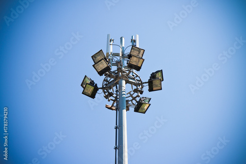 Outdoor train station lights and telecommunication tower against