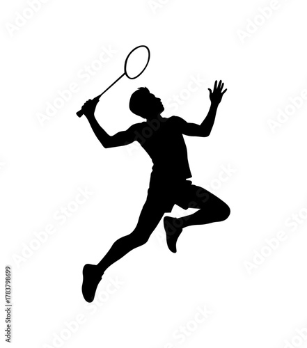 Dynamic silhouette of a badminton player in mid air executing a powerful smash shot during a match