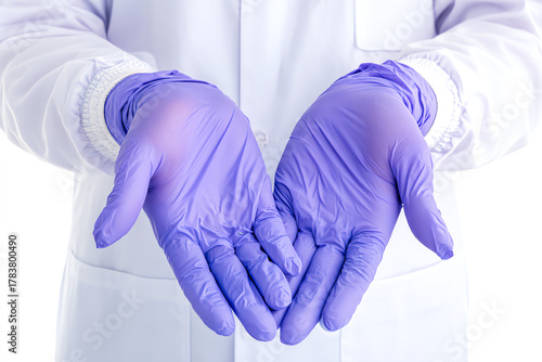 A pair of hands wearing purple latex gloves, ready for medical examination or laboratory work, symbolizing hygiene and safety.
