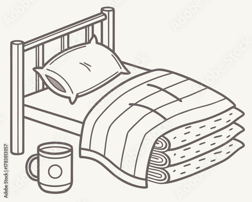 Cozy bed with pillow and stacked blankets and a mug