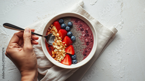 preparing to eat
Healthy breakfast bowl with chia pudding, granola and fresh berries
