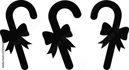 Candy cane silhouette, Christmas sweet vector, holiday dessert illustration, festive bow decoration, winter treat clipart, seasonal graphic design, black isolated artwork