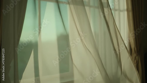 Sheer Curtains Gently Swaying in the Sunlight Creating a Peaceful Ambiance.