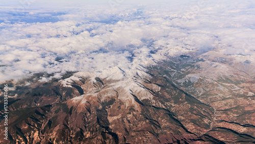Aerial view of the snow capped Alps, rugged mountain peaks landscape.
