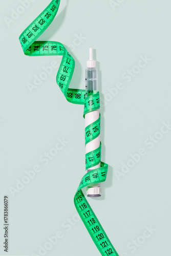 GLP-1 Weight Loss Injection Pen With Measuring Tape On Pastel Background For Anti-Obesity Treatments, Modern Medical Trends, Hormonal Therapy Concepts And Slimming Product Advertising Campaigns