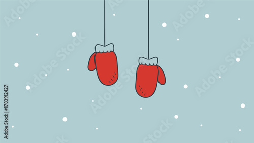 Cozy red mittens hanging against a soft blue background with falling snow
