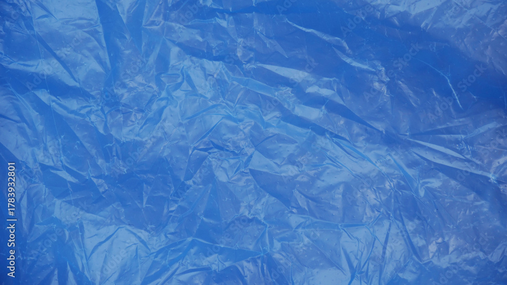 Fototapeta premium Blue plastic texture — glossy crumpled surface background