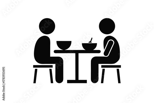 Two simple figures are sitting at a table eating with a spoon