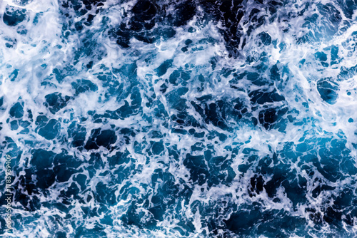 Ocean surface texture. Top view of captivating water with foam. Can be used in covers, packaging, posters, textures, cards, art and design projects. Mesmerizing vector illustration.