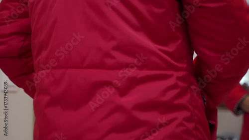 Ready for Adventure: Red Puffer Jacket Snapped Shut with Quick, Crisp Clicks