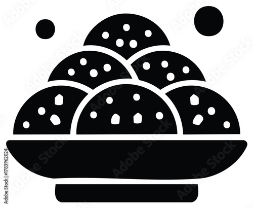 Simple graphic icon of a bowl filled with speckled dessert or snack balls