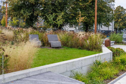 Wooden Loungers in Urban Landscaped Garden with Meadow