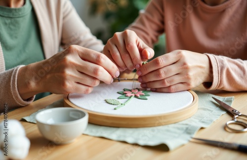 Woman and child working on embroidery project together with embroidery hoop and sewing tools