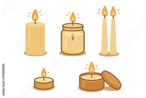 Assortment of burning candles in various shapes and holders