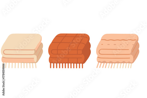 Three folded blankets or throws in warm earthy colors