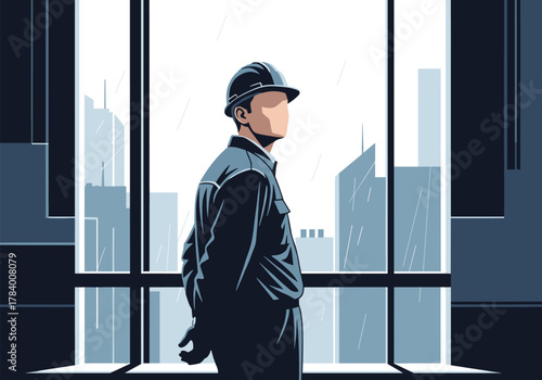 Engineer looking at cityscape through window on a rainy day