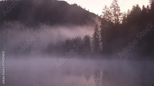 Fog Lifting at Dawnon the Snake River  in Autumn in Grand Teton National Park Wyoming
