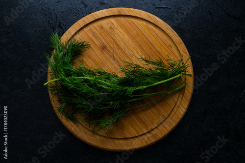 A photo of a kitchen board with herbs on it