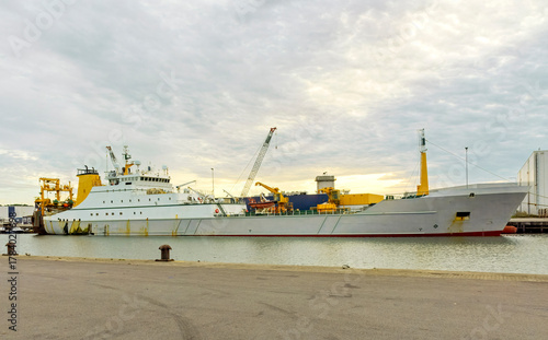 stern trawler is moored at the harbour quay ready to be unloaded