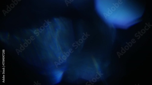 Abstract light leaks on black background with copy space. Studio lens flare bokeh effect. 4k video. Lens Flare Leak Burst Vintage Film Glow Transition.