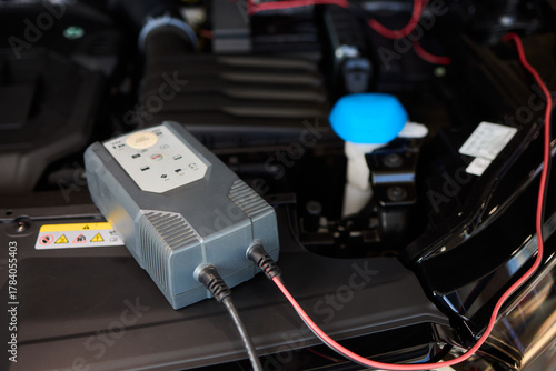 Technician analyzing amplifier during workshop inspection, Audio technician conducting diagnostic analysis of car stereo system under laboratory lighting conditions