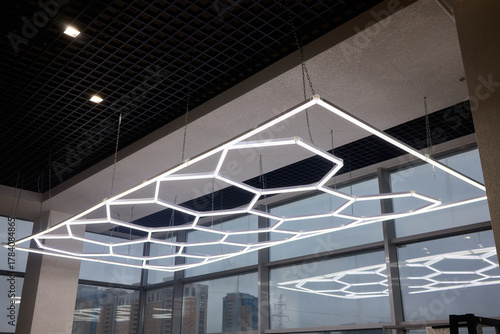 Sleek hexagonal fixtures enhancing modern office and retail environments, Innovative ceiling lighting with geometric shapes to elevate commercial interior aesthetics
