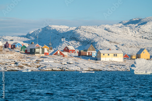 Traditional greenlandic colorful wooden houses in the Oqaatsut village, Ilulissat, Greenland, on a sunny, cold day of late autumn