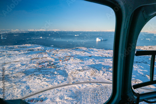 Aerial view of Ilulissat, Greenland, from helicopter on a sunny day of late autumn
