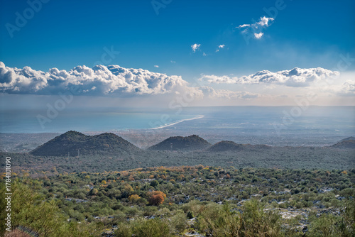 Bird's eye view from the Etna volcano towards the city of Catania and the river Simeto plain. Little volcanic cones in foreground. Catania province, Sicily, italy.