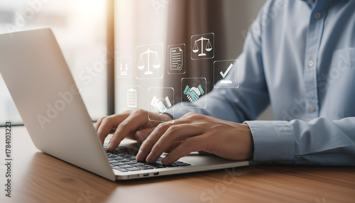 Professional hands typing on laptop surrounded by digital legal and business icons representing contracts agreement and justice