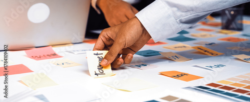 Obraz na plátně A dynamic office scene showcases hands engaged in a brainstorming session, with colorful sticky notes spread across a table, reflecting creativity and collaboration