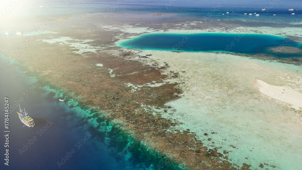Obraz premium Scenic aerial landscape of Pulau Karangan Komodo highlighting coral reef and clear tropical sea