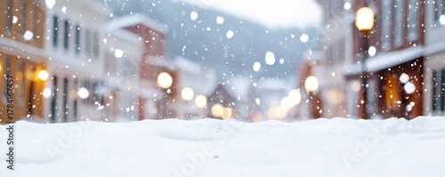  serene winter scene featuring softly falling snowflakes over a snowy street, with blurred buildings and warm lights creating a cozy atmosphere.