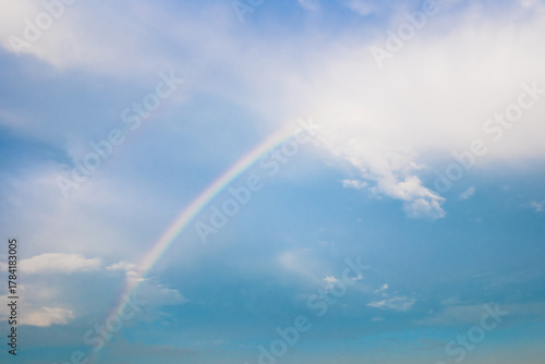 Beautiful summer time blue sky and white cloud between rainbow. Nature background with copy space.