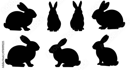 Set of seven black rabbit silhouettes in various poses.