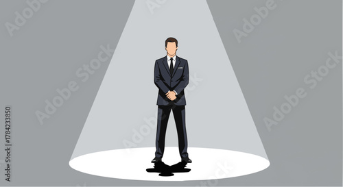 Man in a suit standing in a spotlight, confident and professional.