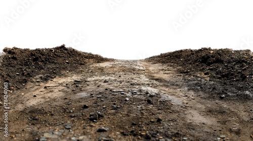 A dirt road with a small hill on either side, leading to a distant horizon.
