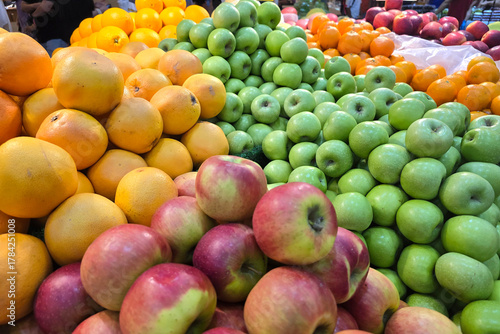 Fresh Apples and Oranges Displayed at Supermarket Produce Section