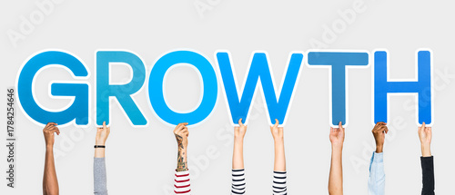 Fotografija Hands holding up blue letters forming the word growth