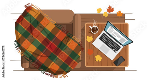 Cozy autumn workspace scene with laptop, coffee, plaid blanket, and fall leaves creates warm, inviting vibe for productivity and relaxation