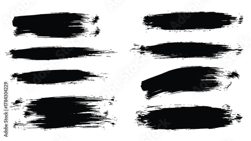 Black grunge vector brush stroke set with bold dry paint smears and textured banners, isolated on white for modern graphic design.