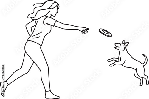 Woman throwing a frisbee for a dog playing outdoors