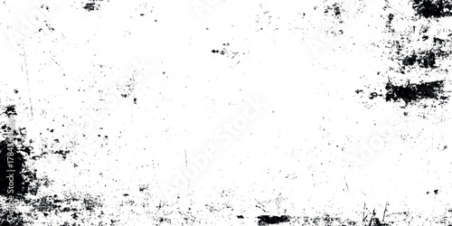 Abstract grunge texture featuring dynamic black ink splatters, scratches, and distressed marks on a clean white background.